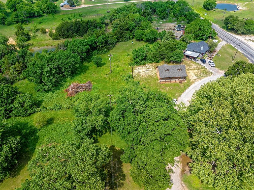 371 Spring Street Forestburg, TX 76239 - Photo 32 of 38 an aerial view of residential house with outdoor space and trees all around
