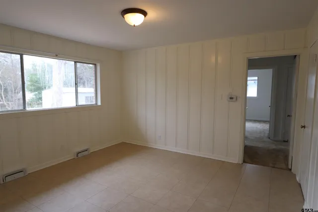 an empty room with a empty space and windows