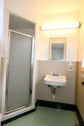 a bathroom with a sink a mirror and a toilet