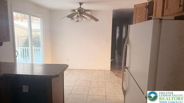 4059 Mauch Chunk Road Coplay, PA 18037 - Photo 11 of 37 a view of kitchen with a refrigerator cabinets and a window