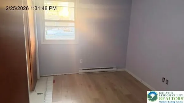 an empty room with a chandelier fan