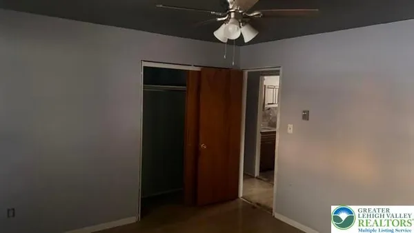 a view of kitchen with a refrigerator cabinets and a window