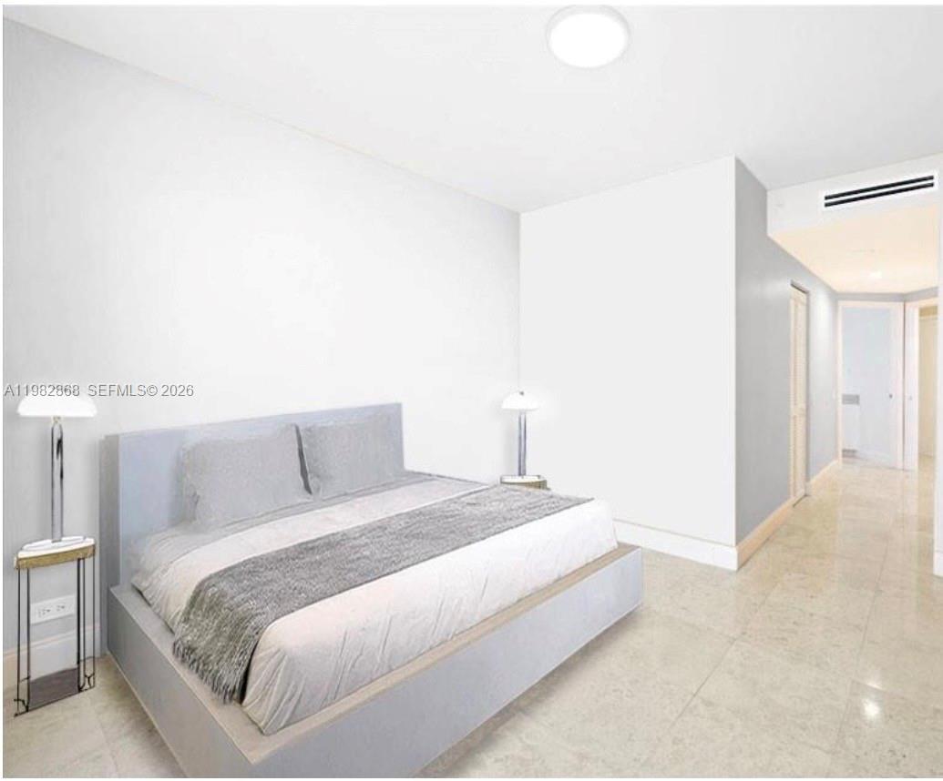 701 Brickell Key Boulevard, Unit 910 Miami, FL 33131 - Photo 13 of 30 a bedroom with a bed and a night stand