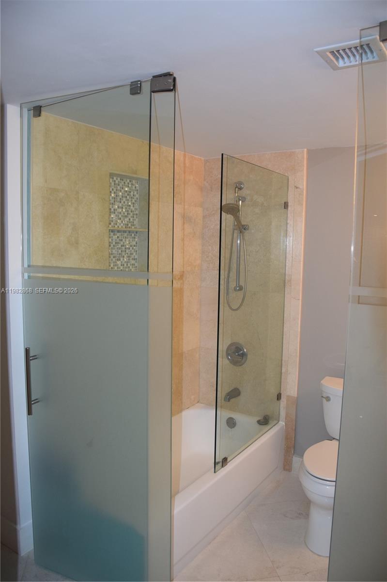 701 Brickell Key Boulevard, Unit 910 Miami, FL 33131 - Photo 14 of 30 a bathroom with a shower a toilet and a shower