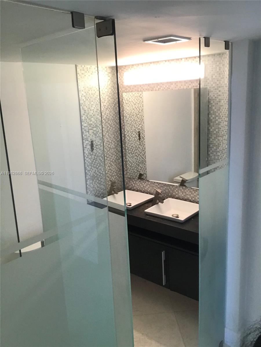 701 Brickell Key Boulevard, Unit 910 Miami, FL 33131 - Photo 15 of 30 a bathroom with a sink and mirror