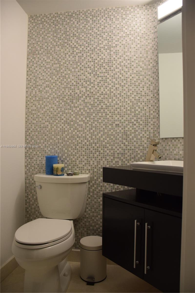 701 Brickell Key Boulevard, Unit 910 Miami, FL 33131 - Photo 16 of 30 a bathroom with a toilet and a sink