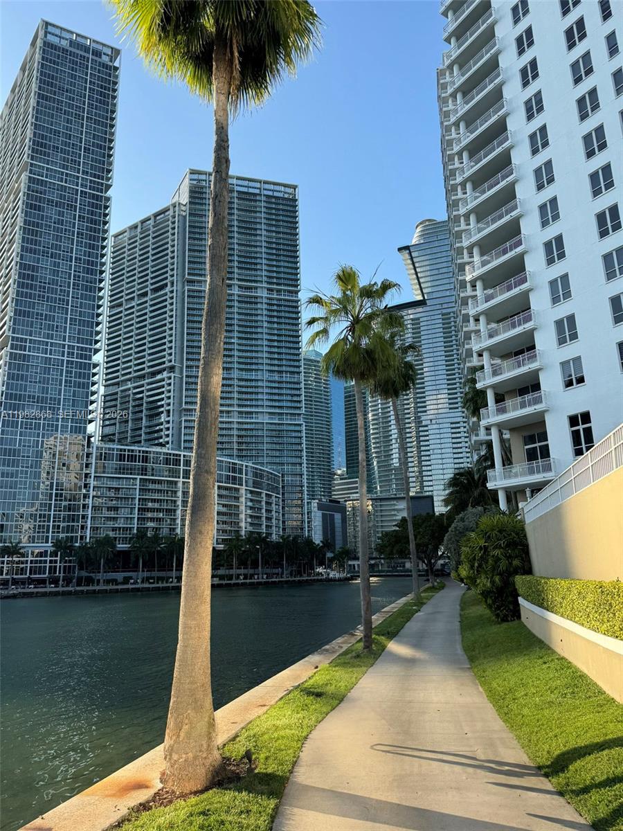 701 Brickell Key Boulevard, Unit 910 Miami, FL 33131 - Photo 18 of 30 a front view of a residential apartment building with a yard