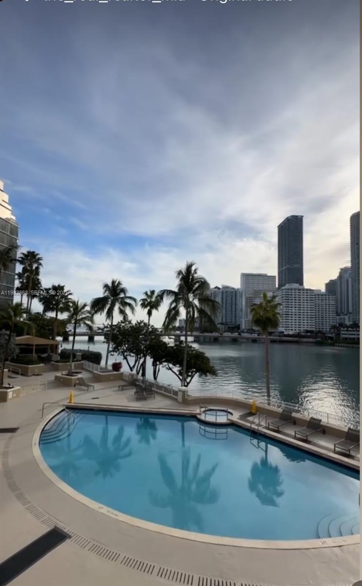 701 Brickell Key Boulevard, Unit 910 Miami, FL 33131 - Photo 23 of 30 a view of a swimming pool with outdoor seating