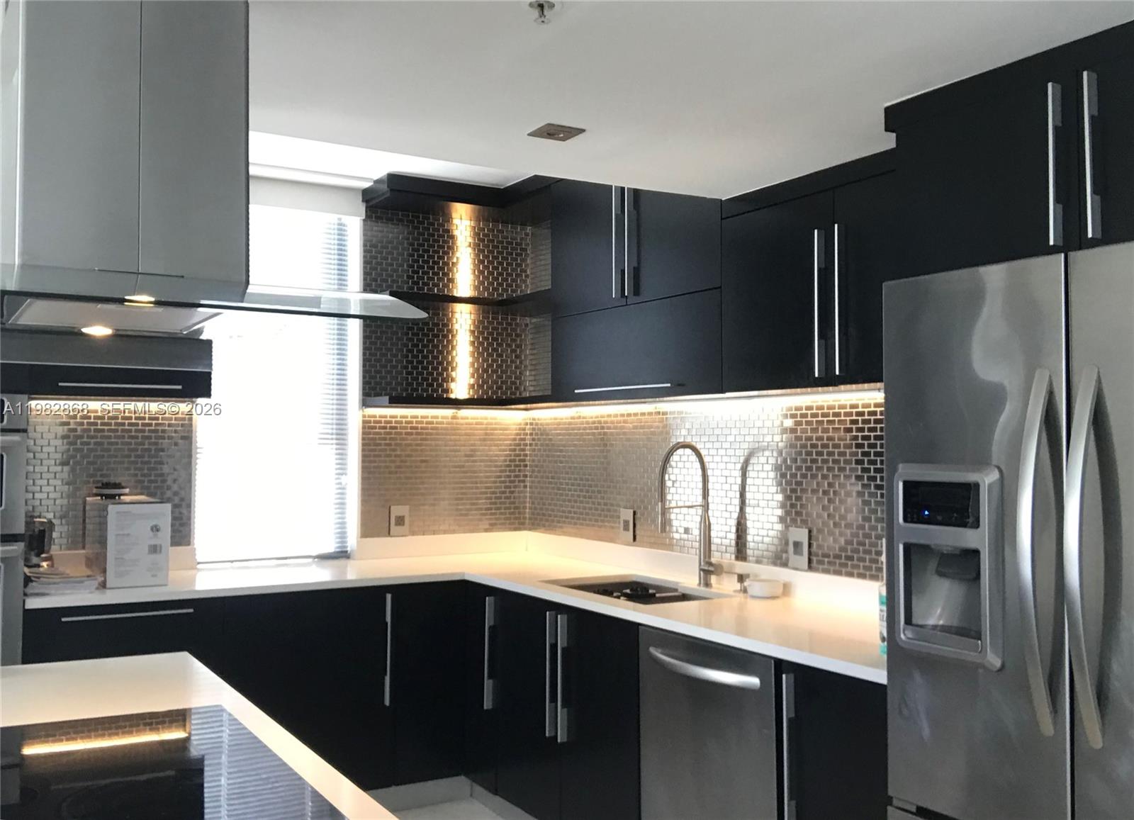 701 Brickell Key Boulevard, Unit 910 Miami, FL 33131 - Photo 3 of 30 a kitchen with a sink and refrigerator