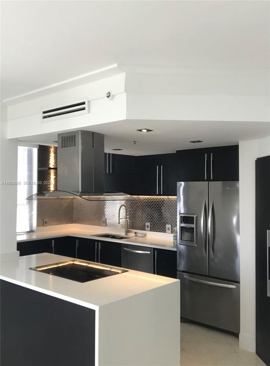 701 Brickell Key Boulevard, Unit 910 Miami, FL 33131 - Photo 5 of 30 a kitchen with stainless steel appliances a refrigerator and a sink