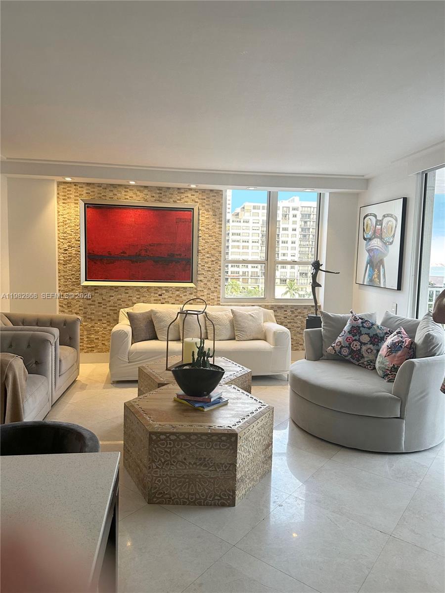 701 Brickell Key Boulevard, Unit 910 Miami, FL 33131 - Photo 7 of 30 a living room with furniture and a large window