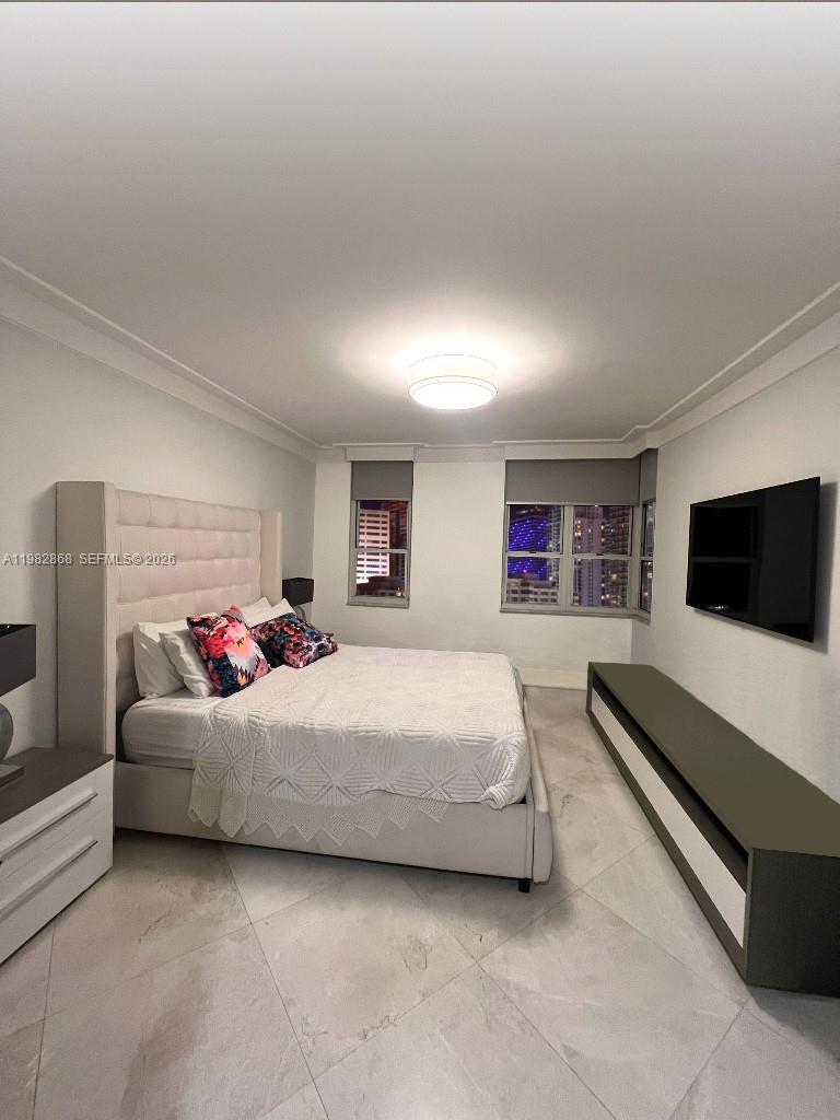 701 Brickell Key Boulevard, Unit 910 Miami, FL 33131 - Photo 10 of 30 a bedroom with a bed and a flat screen tv