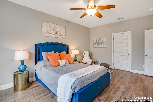 223 Rudolph San Antonio, TX 78202 - Photo 12 of 24 a bedroom with a bed and wooden floor