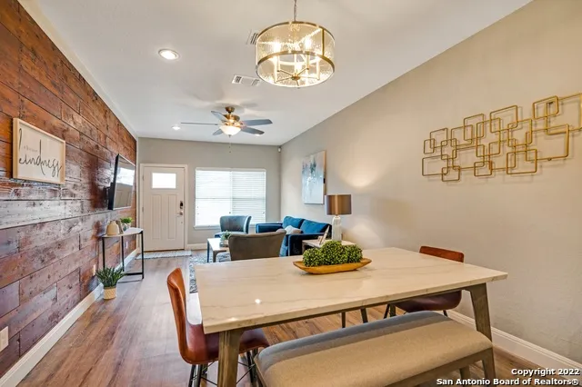 a view of a dining room with furniture and chandelier