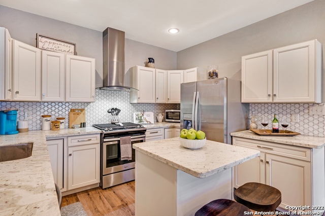 223 Rudolph San Antonio, TX 78202 - Photo 7 of 24 a kitchen with a sink a stove and cabinets
