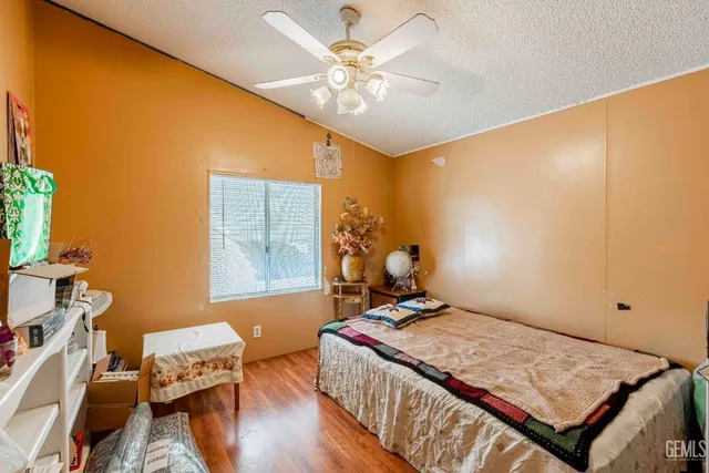 a kitchen with a sink wooden floor and stainless steel appliances