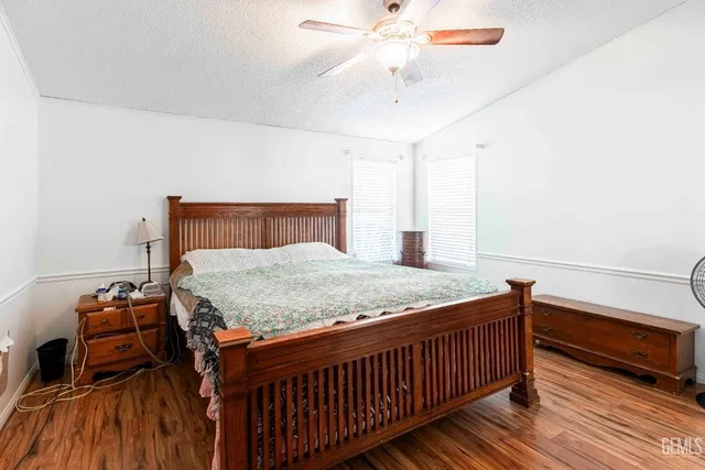 a bed sitting in a bedroom and chair