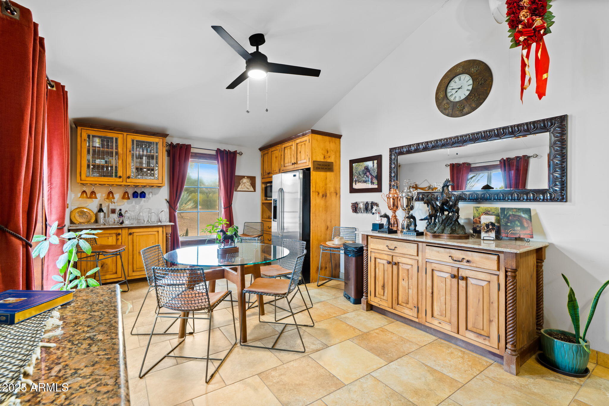 6835 East Peak View Road Scottsdale, AZ 85266 - Photo 36 of 107 a kitchen with stainless steel appliances granite countertop a stove and a dining table