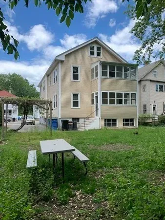 a front view of a house with a yard and porch