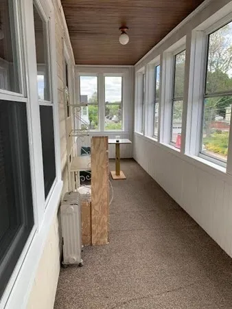 a room with furniture and large windows