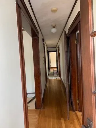 a view of an entryway with wooden floor