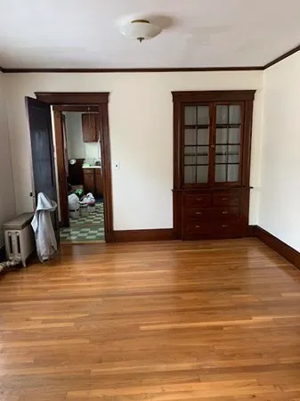a view of a room with wooden floor and furniture