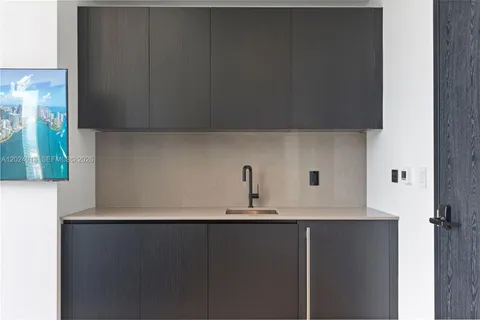 a kitchen with a sink and a refrigerator