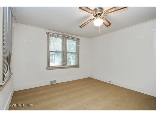 122 Eagle Point Road Fox Lake, IL 60020 - Photo 5 of 11 an empty room with windows and fan