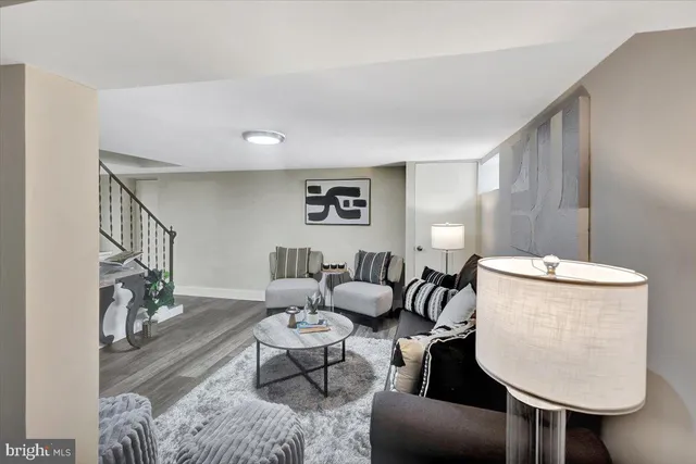 a living room with furniture and a painting