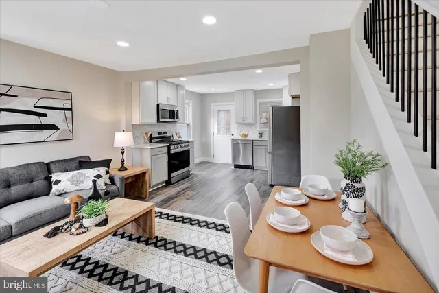 a living room with furniture and a dining table