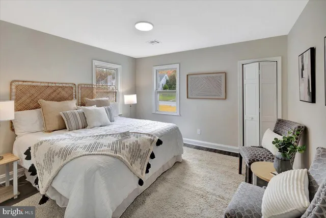 a spacious bedroom with a bed and a couch