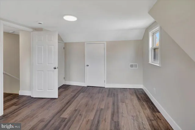 a view of a room with wooden floor