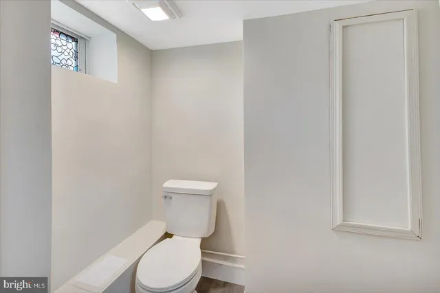 a white toilet sitting next to a shower