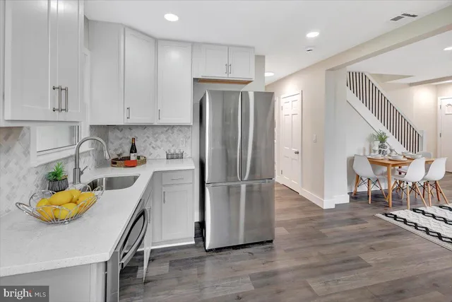 a kitchen with a refrigerator and a sink