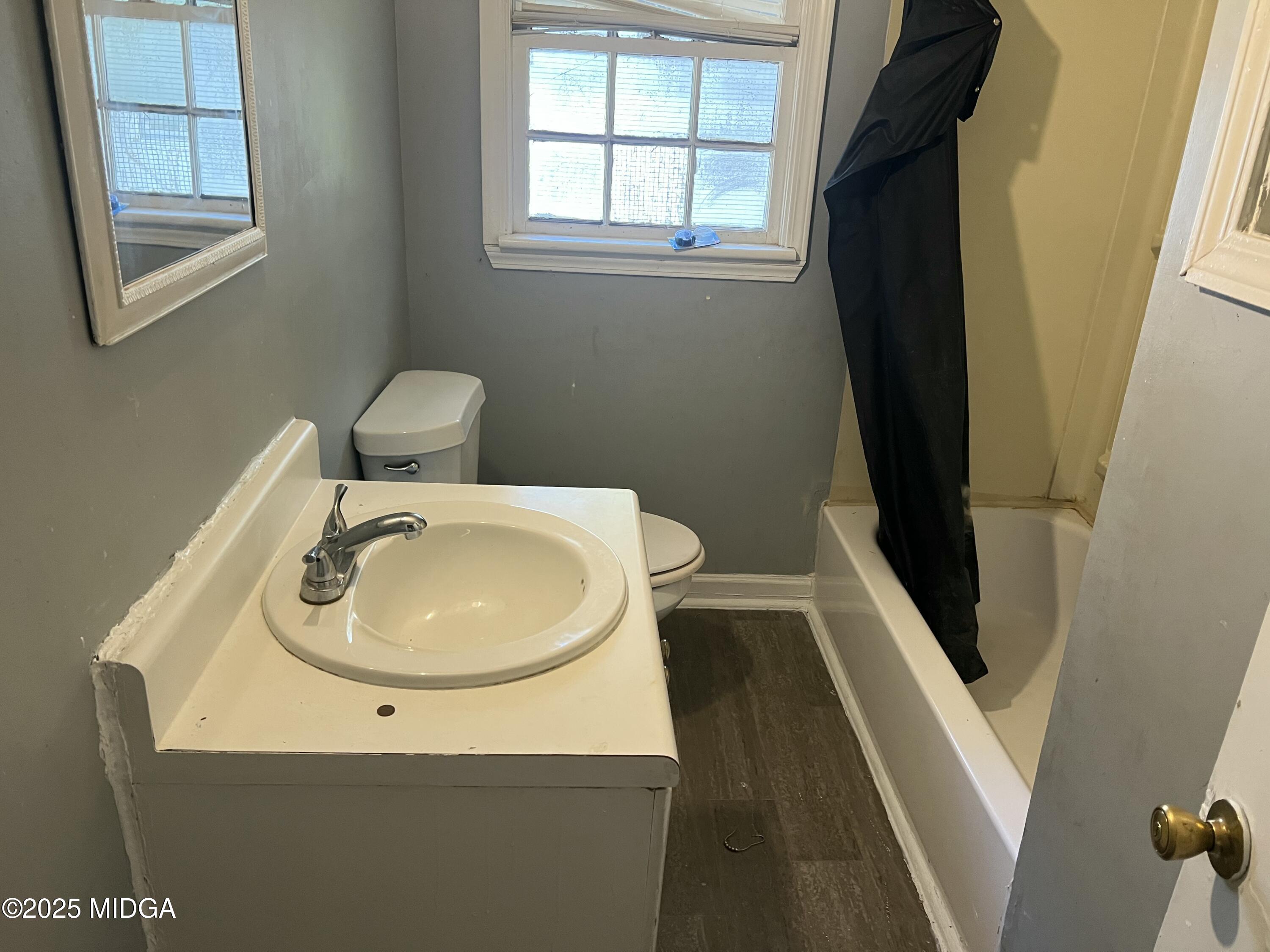 3811 Lyons Street Macon, GA 31206 - Photo 6 of 14 a bathroom with a sink and a mirror