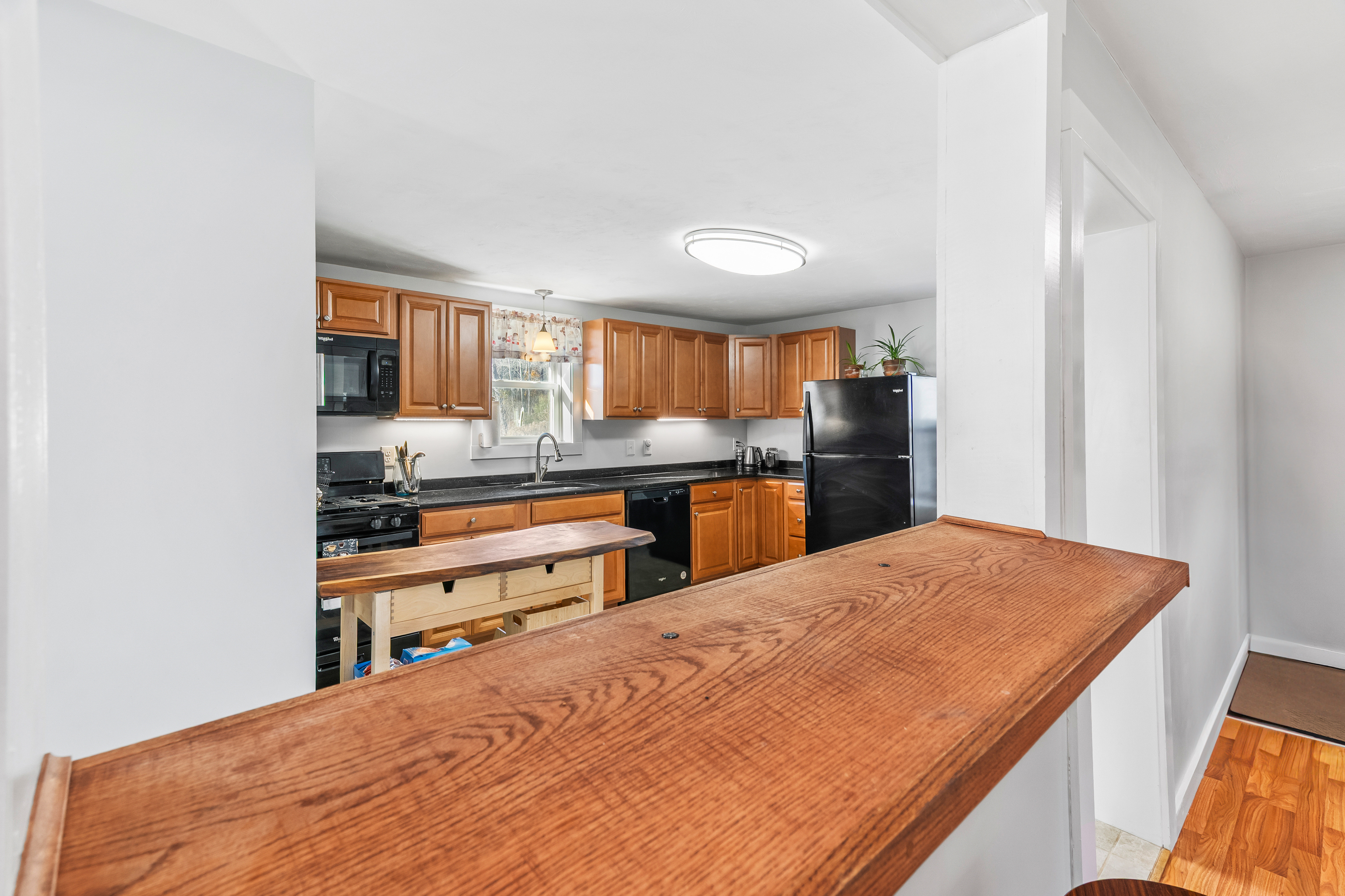 290 Providence Pike Putnam, CT 06260 - Photo 12 of 34 a kitchen with stainless steel appliances kitchen island granite countertop a refrigerator and cabinets