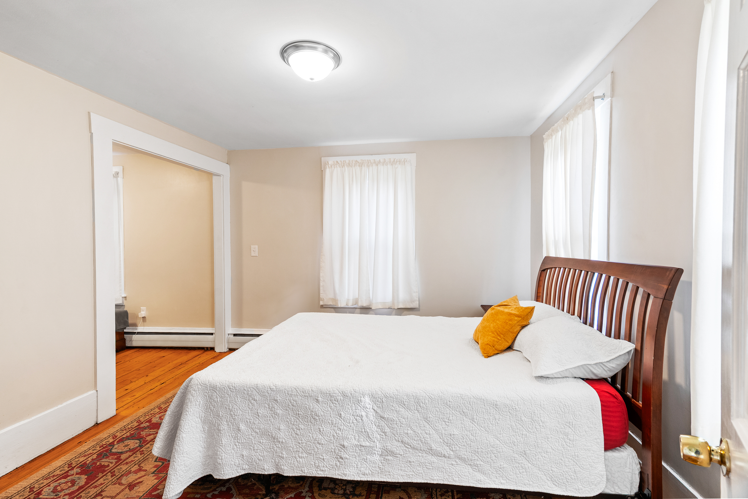 290 Providence Pike Putnam, CT 06260 - Photo 15 of 34 a bedroom with a bed and sliding window