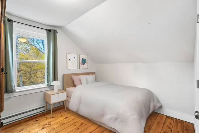 a bedroom with a bed and window