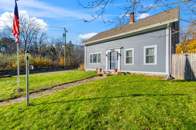 a view of a house with backyard and porch