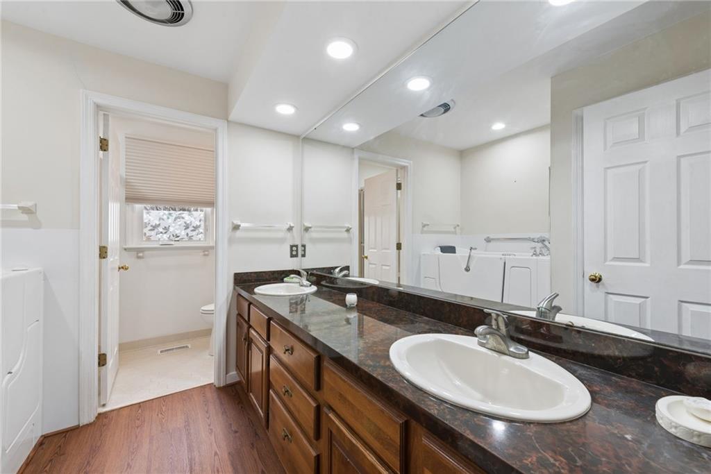 64 Fox Pointe Place Pittsburgh, PA 15238 - Photo 21 of 32 a bathroom with a granite countertop sink a toilet a mirror and shower