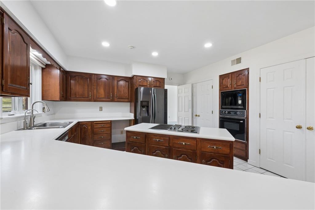 64 Fox Pointe Place Pittsburgh, PA 15238 - Photo 10 of 32 a view of kitchen with stainless steel appliances granite countertop a sink and cabinets