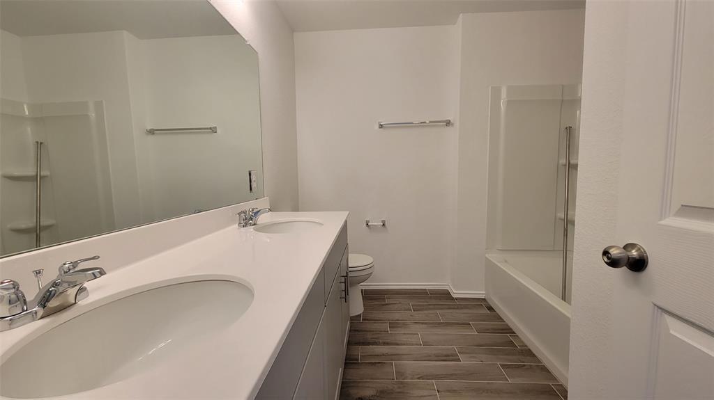 452 Pickrell Loop Georgetown, TX 78628 - Photo 10 of 19 Full bathroom with double vanity, wood tiled floors, and shower / washtub combination