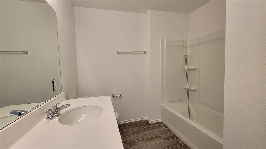 452 Pickrell Loop Georgetown, TX 78628 - Photo 11 of 19 Bathroom featuring wood tiled floors, vanity, and shower / bath combination