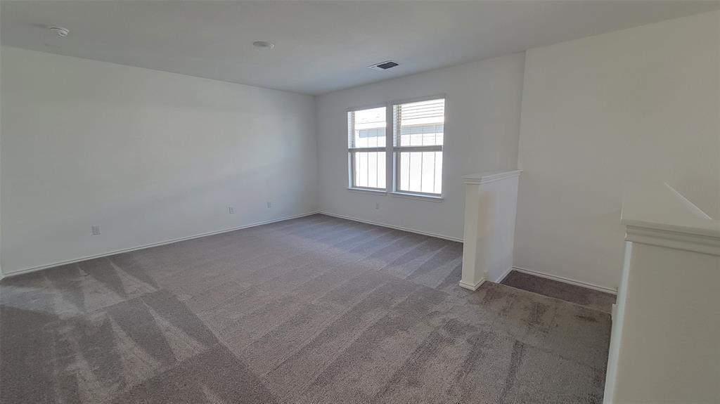 452 Pickrell Loop Georgetown, TX 78628 - Photo 12 of 19 Spare room featuring dark carpet and baseboards