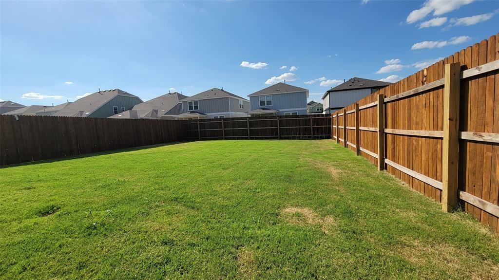 452 Pickrell Loop Georgetown, TX 78628 - Photo 17 of 19 Fenced backyard featuring a residential view