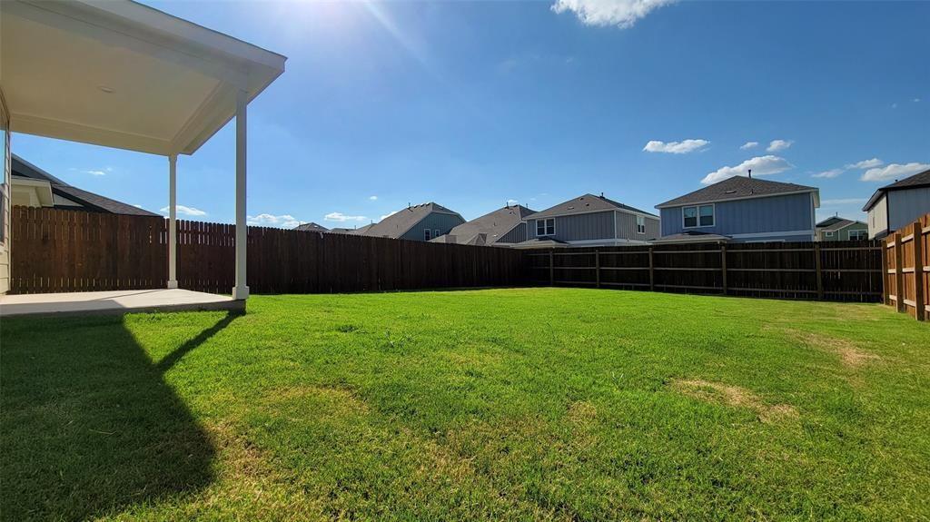 452 Pickrell Loop Georgetown, TX 78628 - Photo 18 of 19 Fenced backyard featuring a residential view and a patio