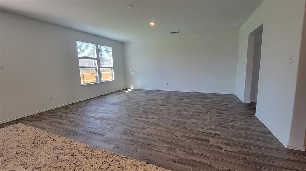 452 Pickrell Loop Georgetown, TX 78628 - Photo 7 of 19 Spare room with wood tiled floors and recessed lighting