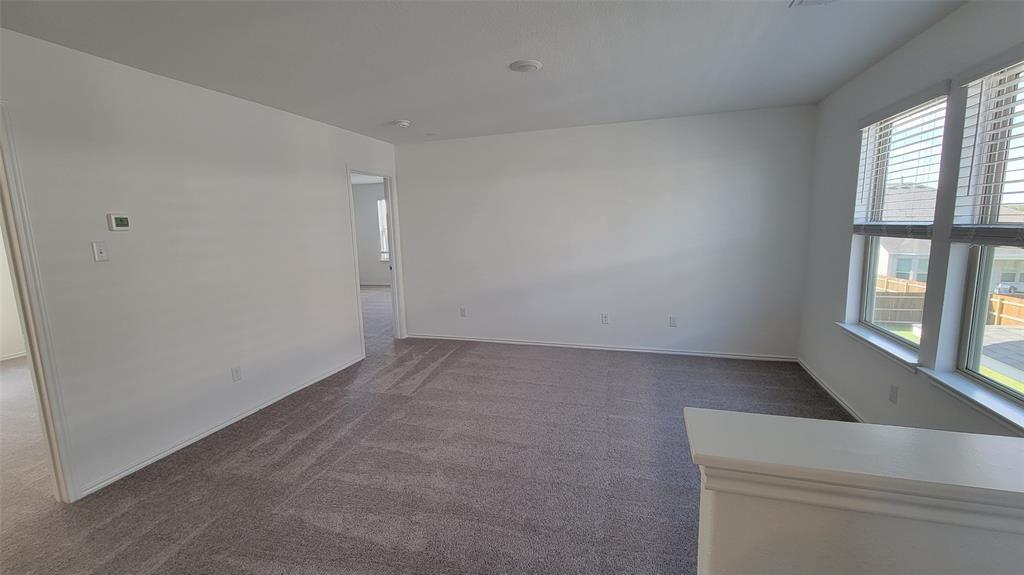 452 Pickrell Loop Georgetown, TX 78628 - Photo 8 of 19 Spare room with dark carpet and baseboards