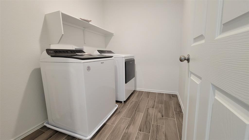 452 Pickrell Loop Georgetown, TX 78628 - Photo 9 of 19 Laundry area with wood finish floors and washer and dryer
