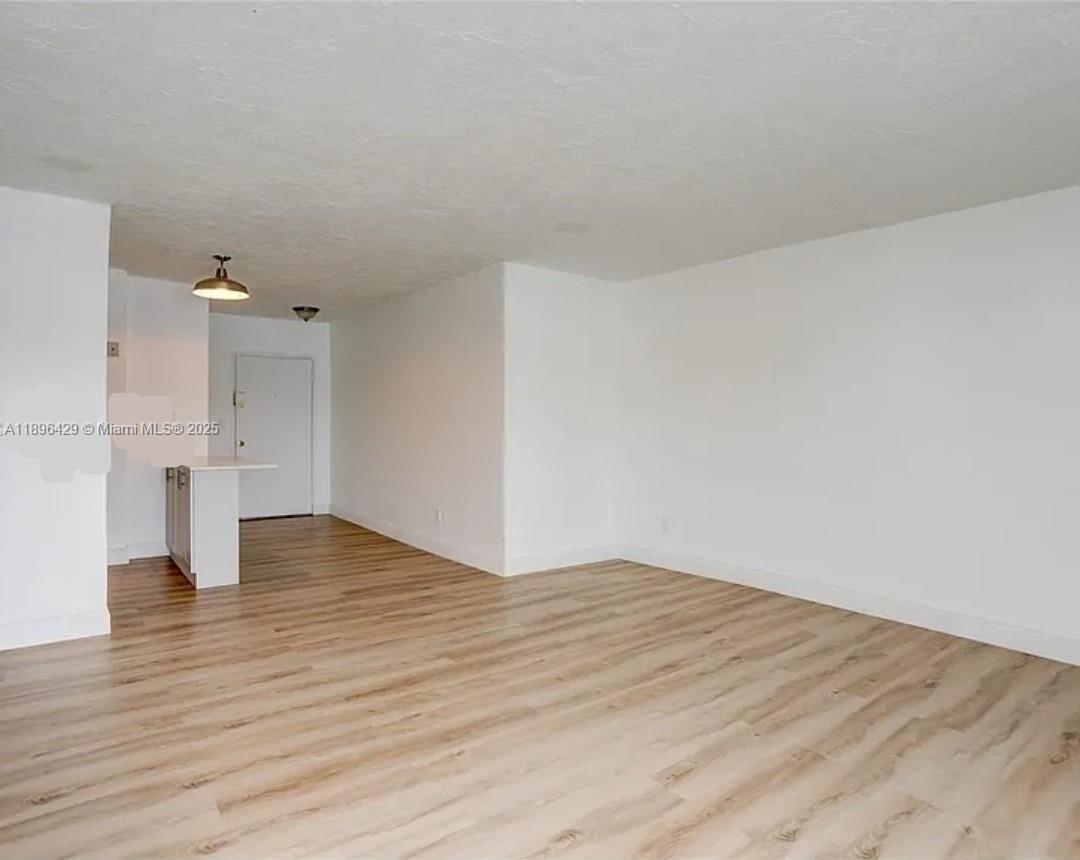 5501 Northwest 7th Street, Unit E408 Miami, FL 33126 - Photo 12 of 27 a view of empty room with wooden floor